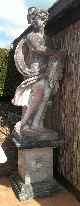 A pair of reconstituted stone garden statues modelled as a classical hunter and a maiden height overall 7ft 7in.